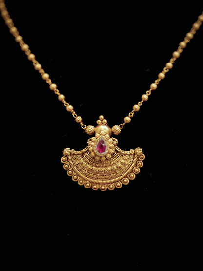Traditional design tear drop ruby stone pendant set in gold bead chain
