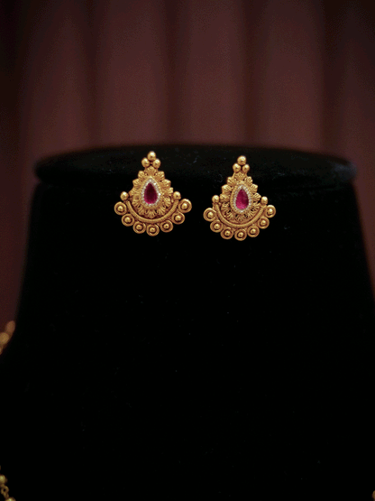 Traditional design tear drop ruby stone pendant set in gold bead chain