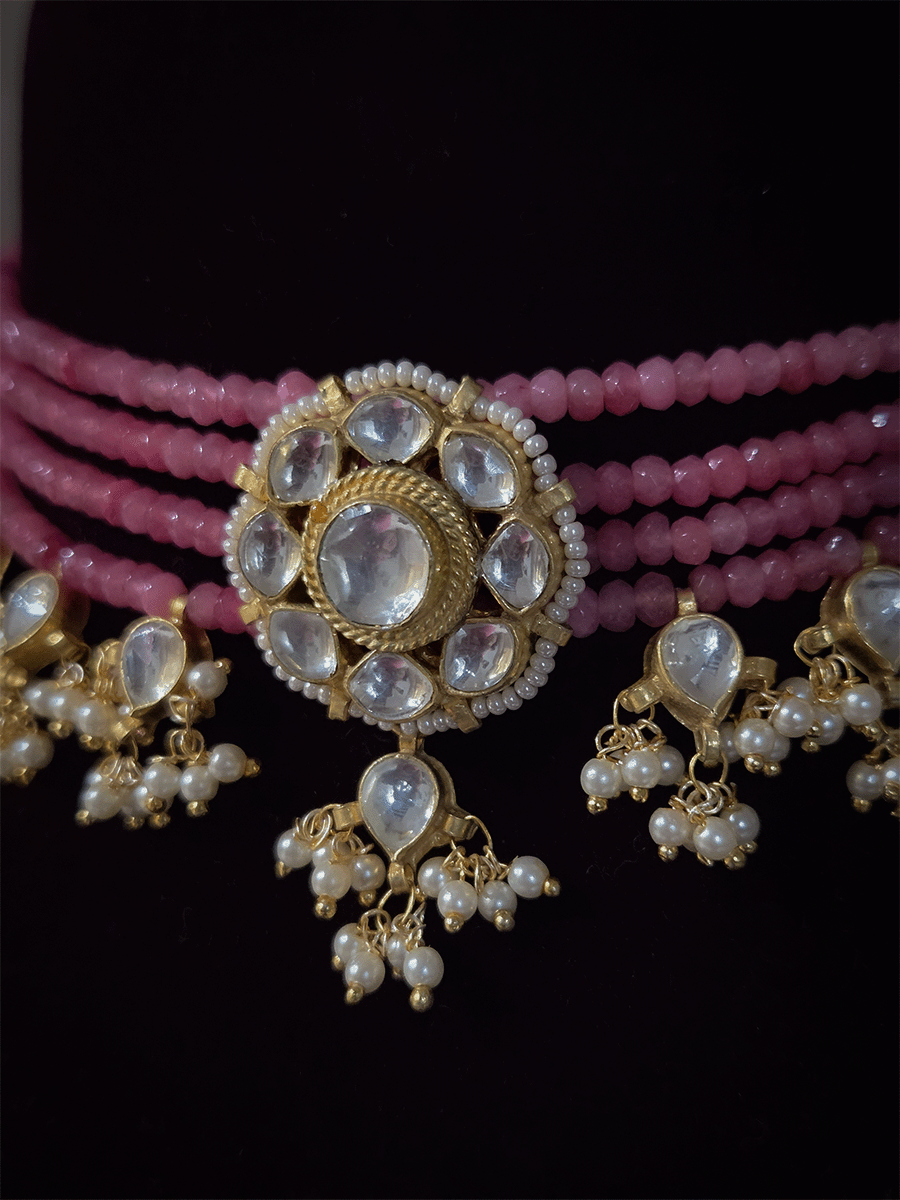 Four peach strings set with center kundan flower with pirohi and hanging kundan drops