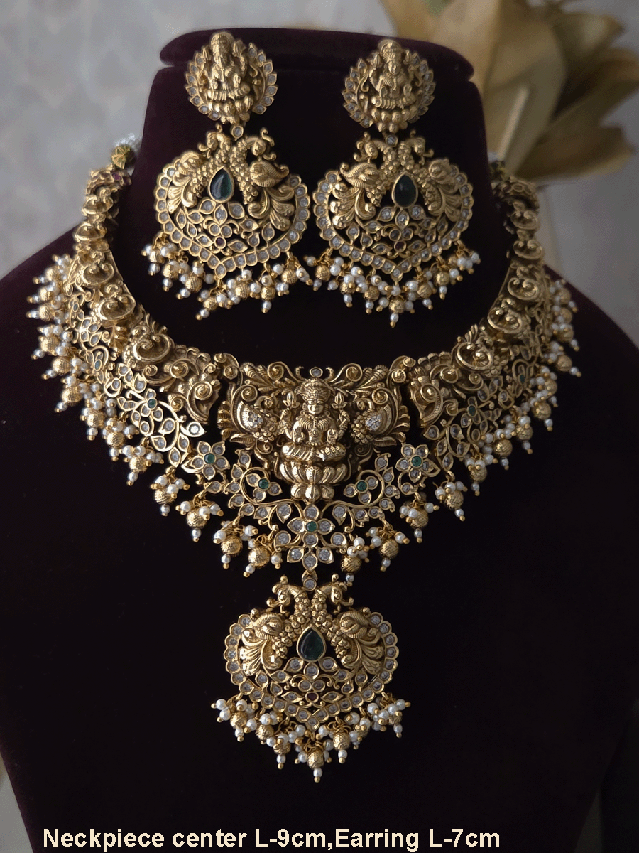 Polki and green stones studded Laxmiji center motif with peacock design set