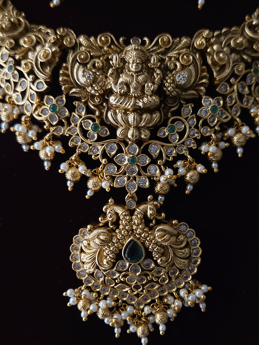 Polki and green stones studded Laxmiji center motif with peacock design set