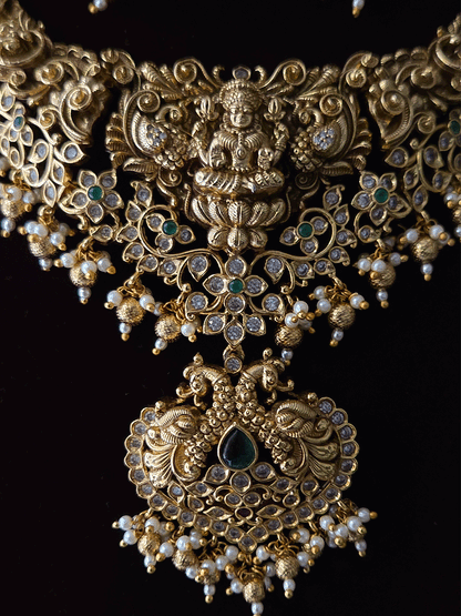 Polki and green stones studded Laxmiji center motif with peacock design set