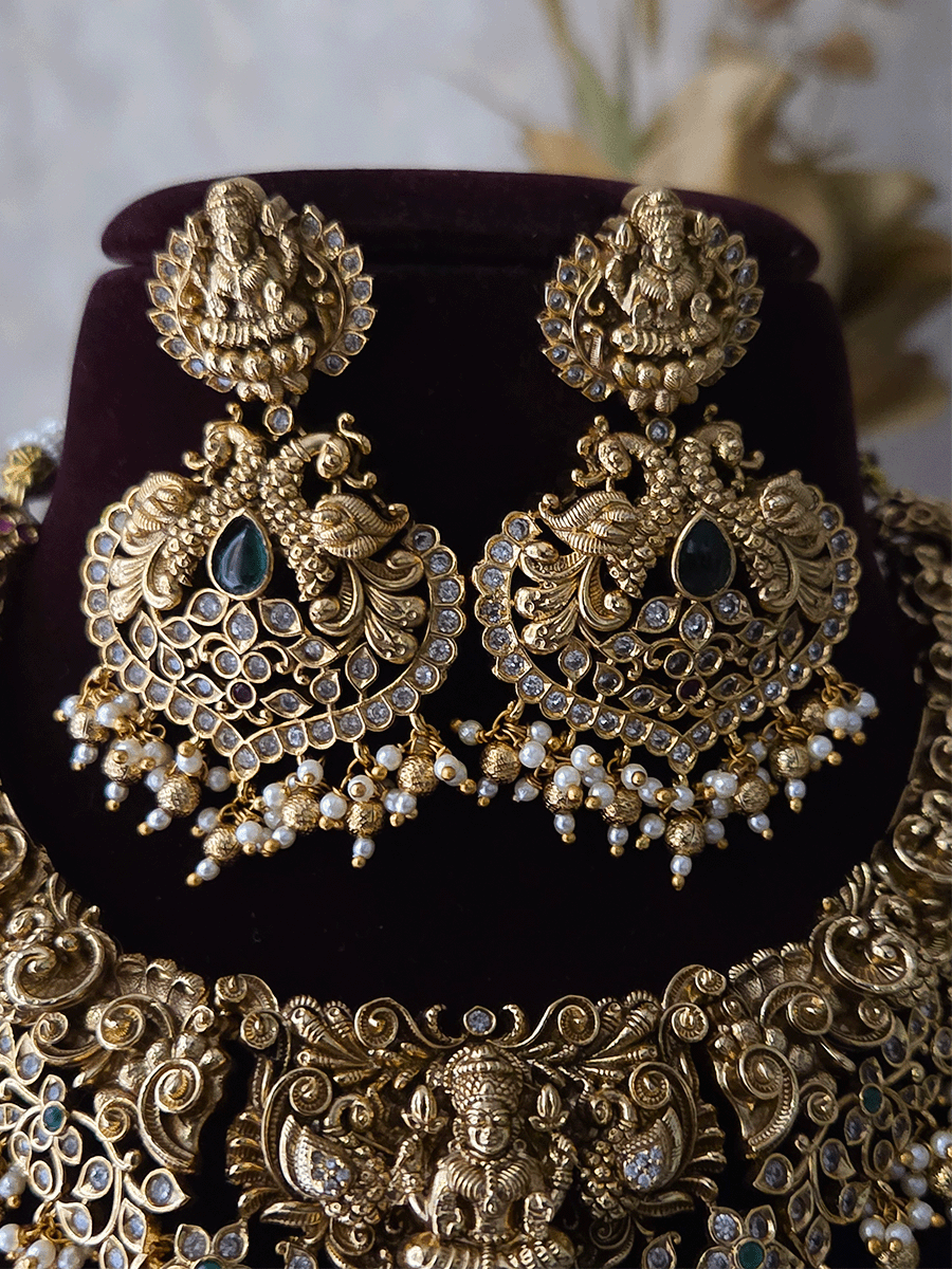 Polki and green stones studded Laxmiji center motif with peacock design set