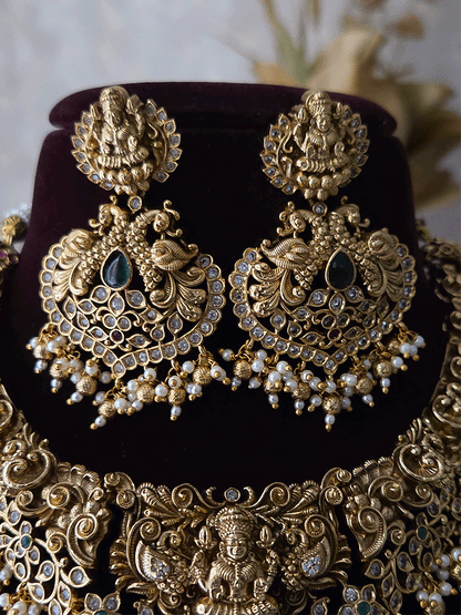 Polki and green stones studded Laxmiji center motif with peacock design set
