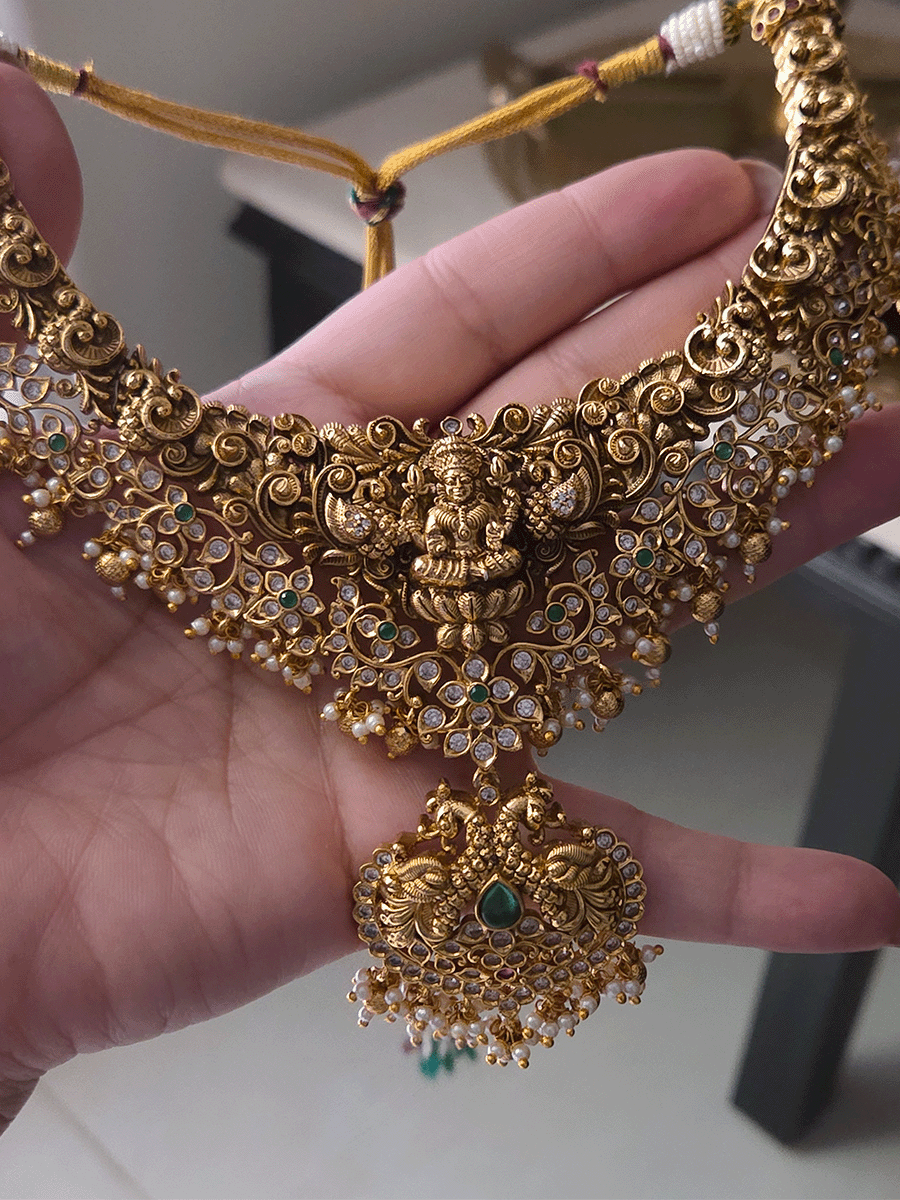 Polki and green stones studded Laxmiji center motif with peacock design set