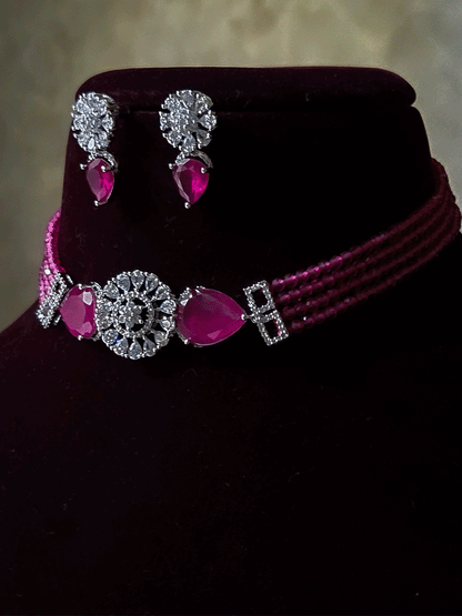 Circular center AD flower with side tear shaped stone and four onyx bead strings set