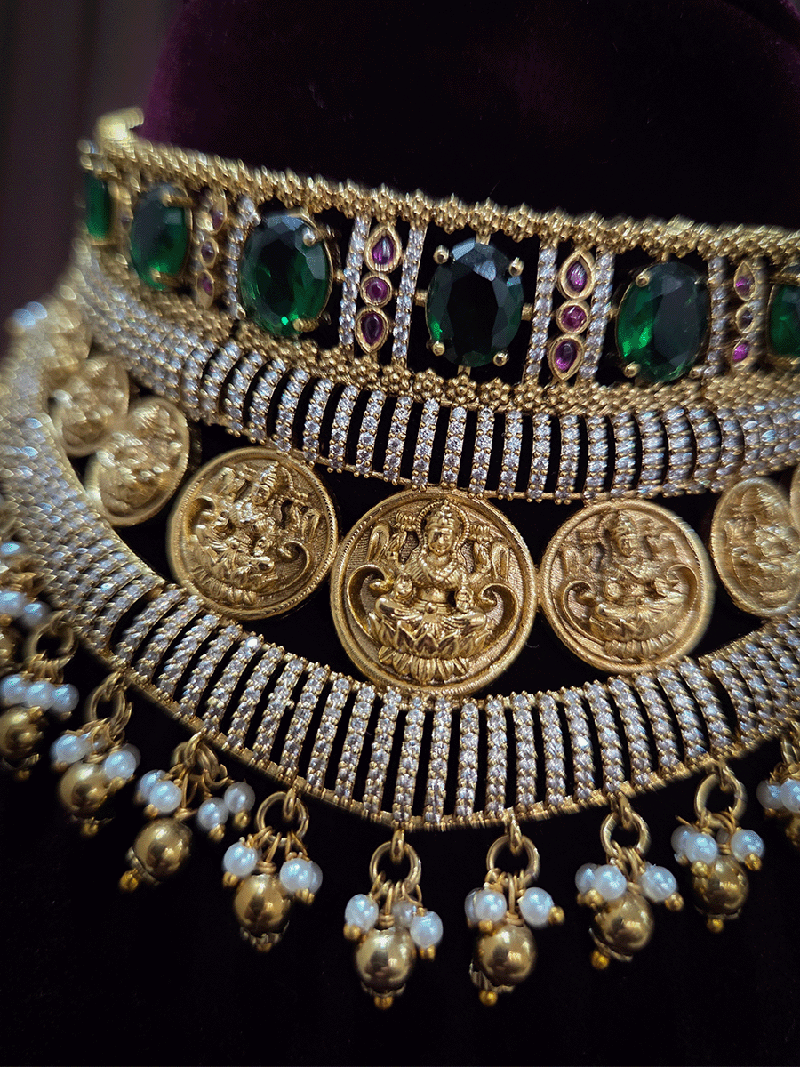 Zircon studded laxmiji motif's broad choker set with oval green stones