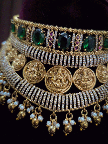 Zircon studded laxmiji motif's broad choker set with oval green stones
