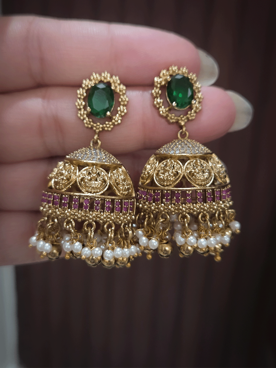 Zircon studded laxmiji motif's broad choker set with oval green stones