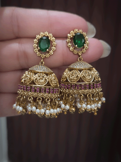Zircon studded laxmiji motif's broad choker set with oval green stones