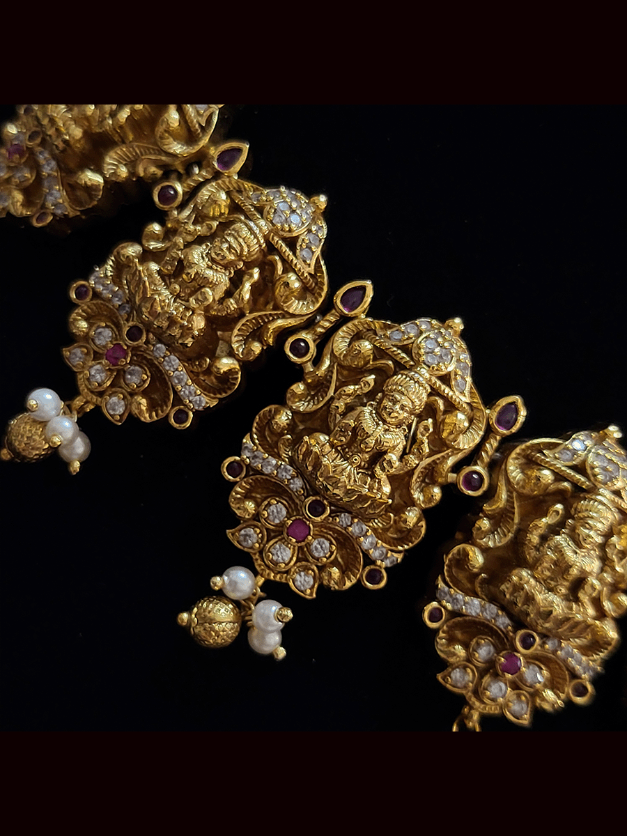 Laxmiji tukdies studded with ruby stones and zircons and pearly hangings set
