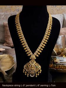 Laxmiji pendant studded with green stones and AD with leaf design string with polki