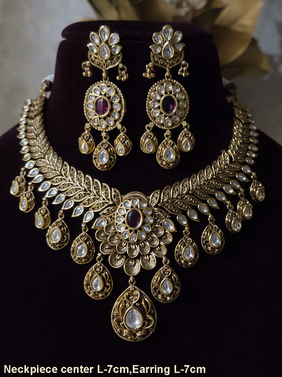Oval ruby stone with tear shaped kundan drops connecting leaf tukdies kundan set