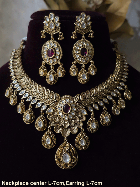 Oval ruby stone with tear shaped kundan drops connecting leaf tukdies kundan set