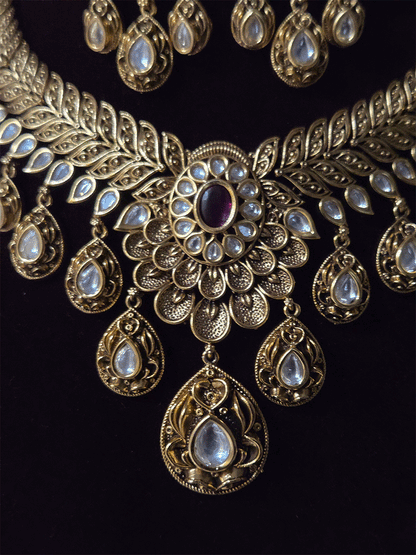 Oval ruby stone with tear shaped kundan drops connecting leaf tukdies kundan set