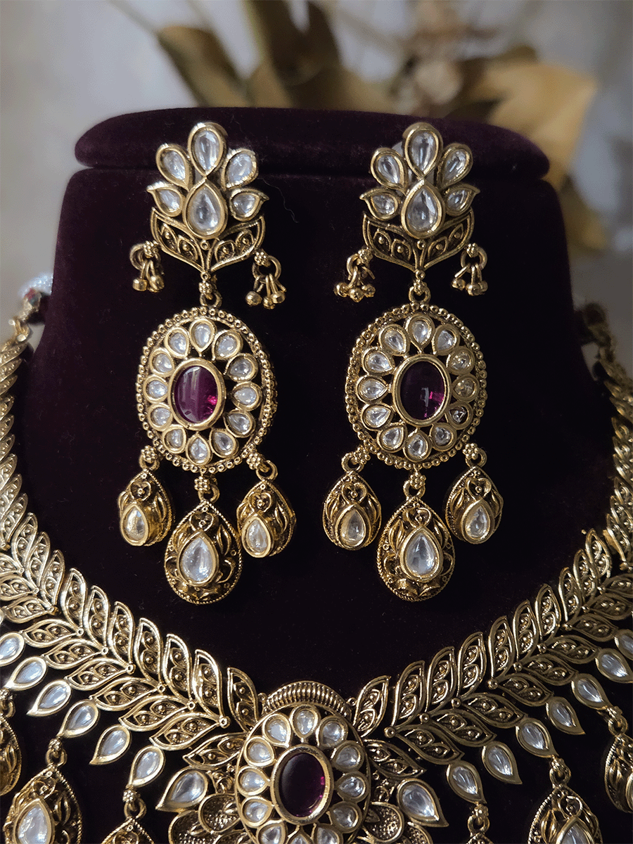 Oval ruby stone with tear shaped kundan drops connecting leaf tukdies kundan set