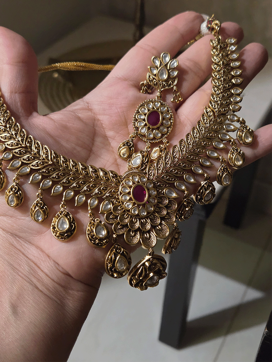 Oval ruby stone with tear shaped kundan drops connecting leaf tukdies kundan set