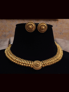 Circular tukdi center gold finish set with flower engraved on gold bead design