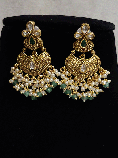 Intricate design antique gold finish kundan and stones studded pearly frill set