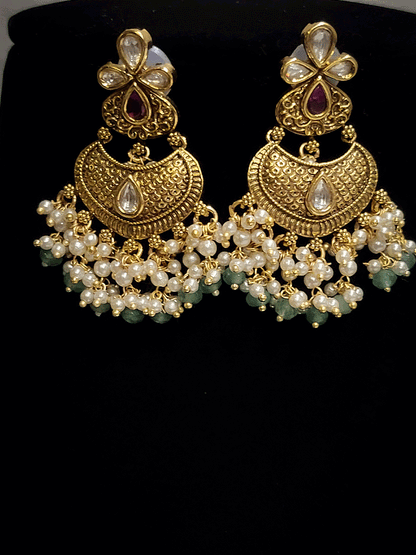Intricate design antique gold finish kundan and stones studded pearly frill set