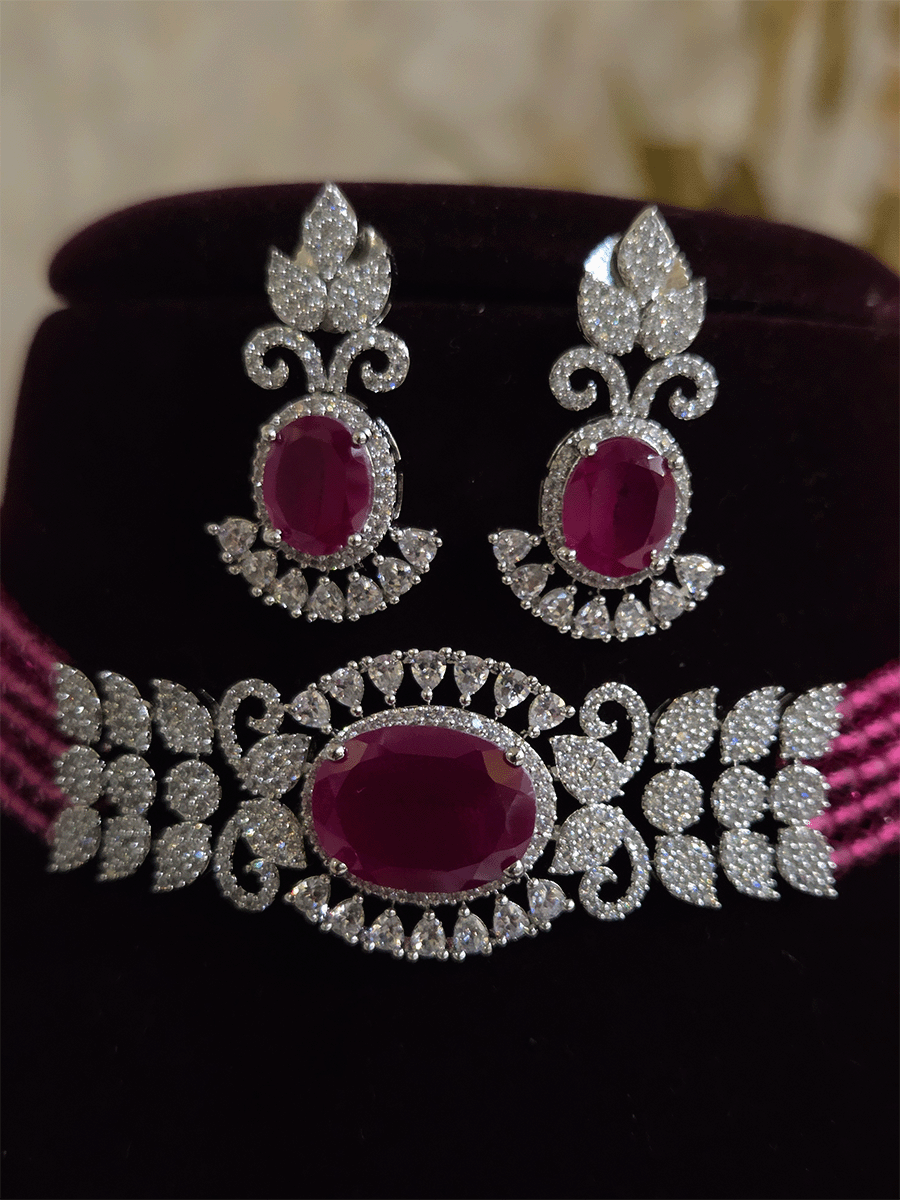 Oval coloured stone in center with AD leaf design and onyx side strings set