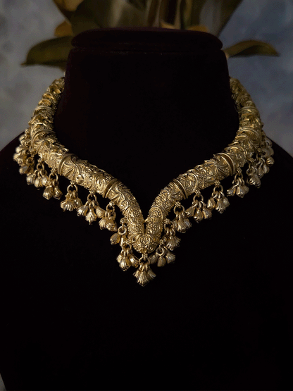 Gold finish self design hasli neckpiece with ghunghru hangings