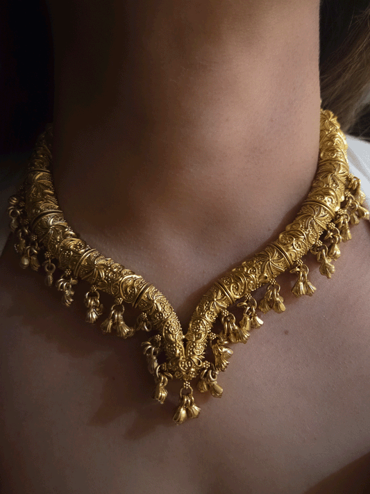 Gold finish self design hasli neckpiece with ghunghru hangings