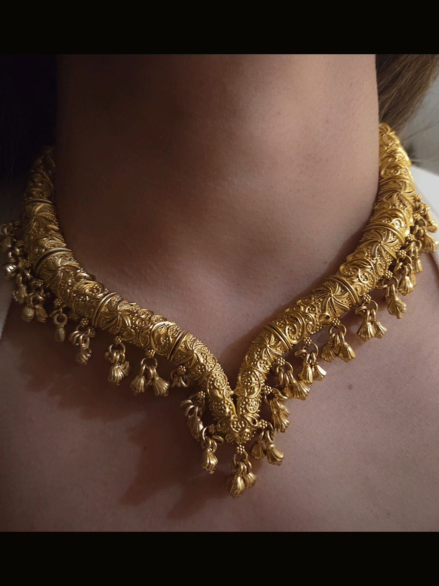 Gold finish self design hasli neckpiece with ghunghru hangings