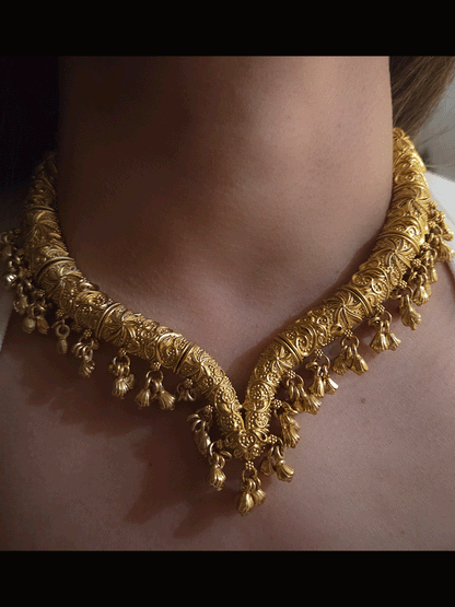Gold finish self design hasli neckpiece with ghunghru hangings