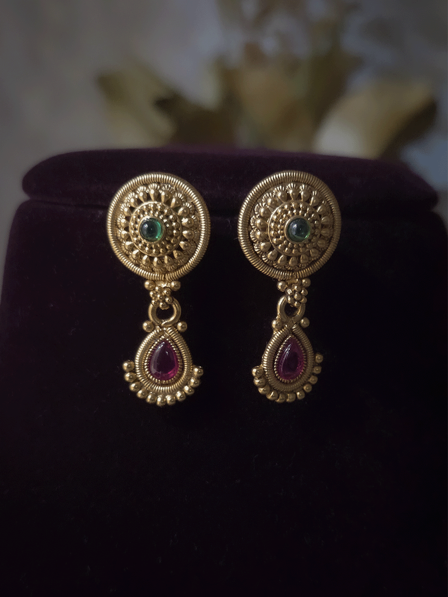 Circular tukdies with coloured stones sleek set with hanging tear drop shaped peacock tukdi in center