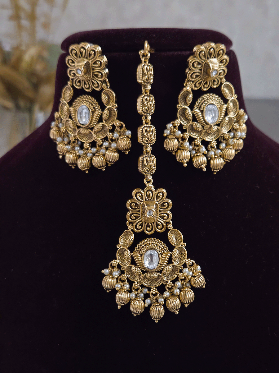 Intricate oval design kundan studded side cheed strings with golden tukdies set