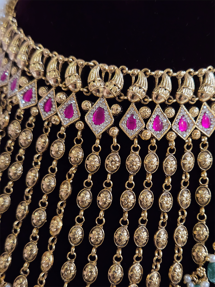 Golden tukdi tassels with green bead drops and paisley design top ruby stones set