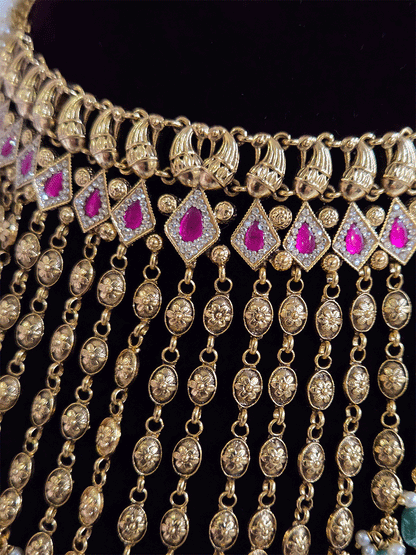 Golden tukdi tassels with green bead drops and paisley design top ruby stones set