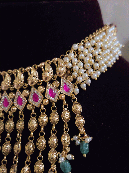 Golden tukdi tassels with green bead drops and paisley design top ruby stones set