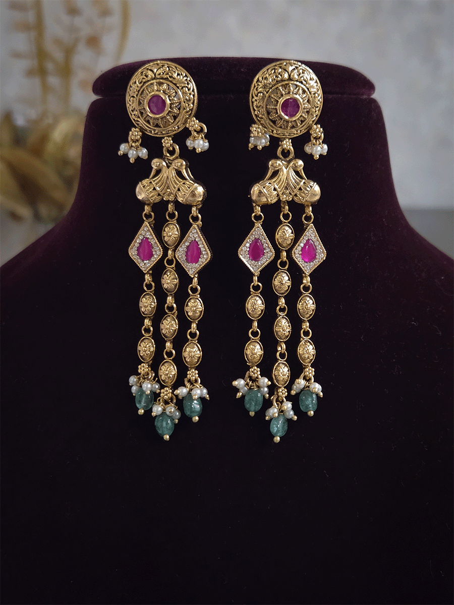 Golden tukdi tassels with green bead drops and paisley design top ruby stones set
