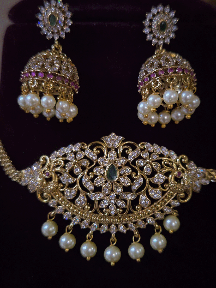 Zircon studded side peacock design with green stone center sleek set with pearl drops
