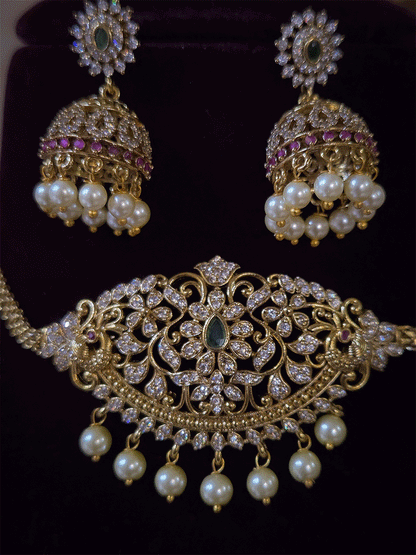 Zircon studded side peacock design with green stone center sleek set with pearl drops