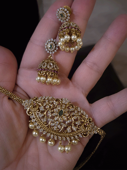 Zircon studded side peacock design with green stone center sleek set with pearl drops