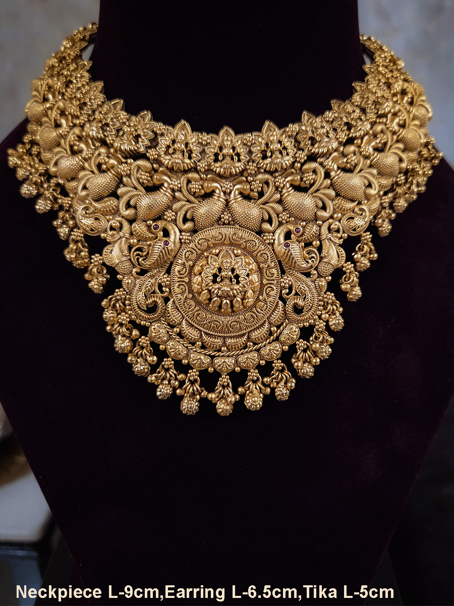 Laxmiji motif in circular design center and on neckline of peacock design broad set with ghunghru hangings