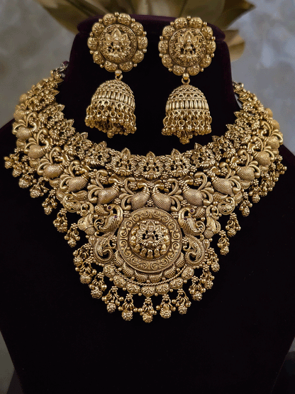 Laxmiji motif in circular design center and on neckline of peacock design broad set with ghunghru hangings