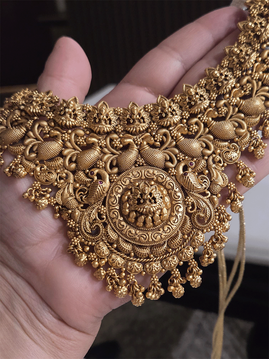 Laxmiji motif in circular design center and on neckline of peacock design broad set with ghunghru hangings