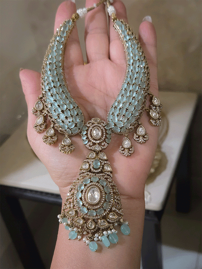 Oval shaped moissanite pendant with stones studded hasli set in mehandi finish