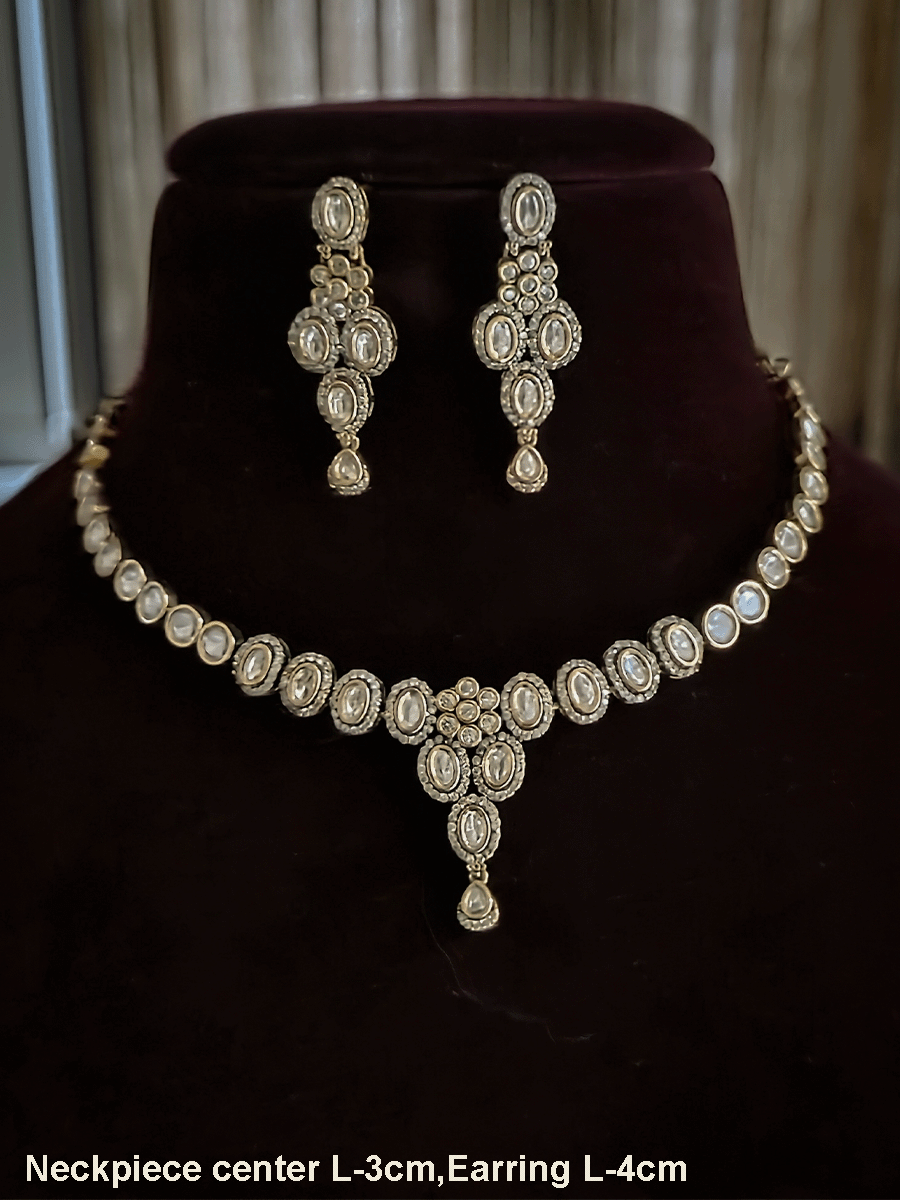 Flower in center of oval moissanite setting sleek antique gold finish set