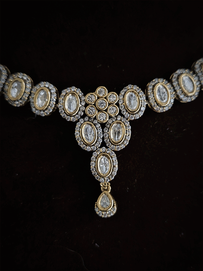 Flower in center of oval moissanite setting sleek antique gold finish set