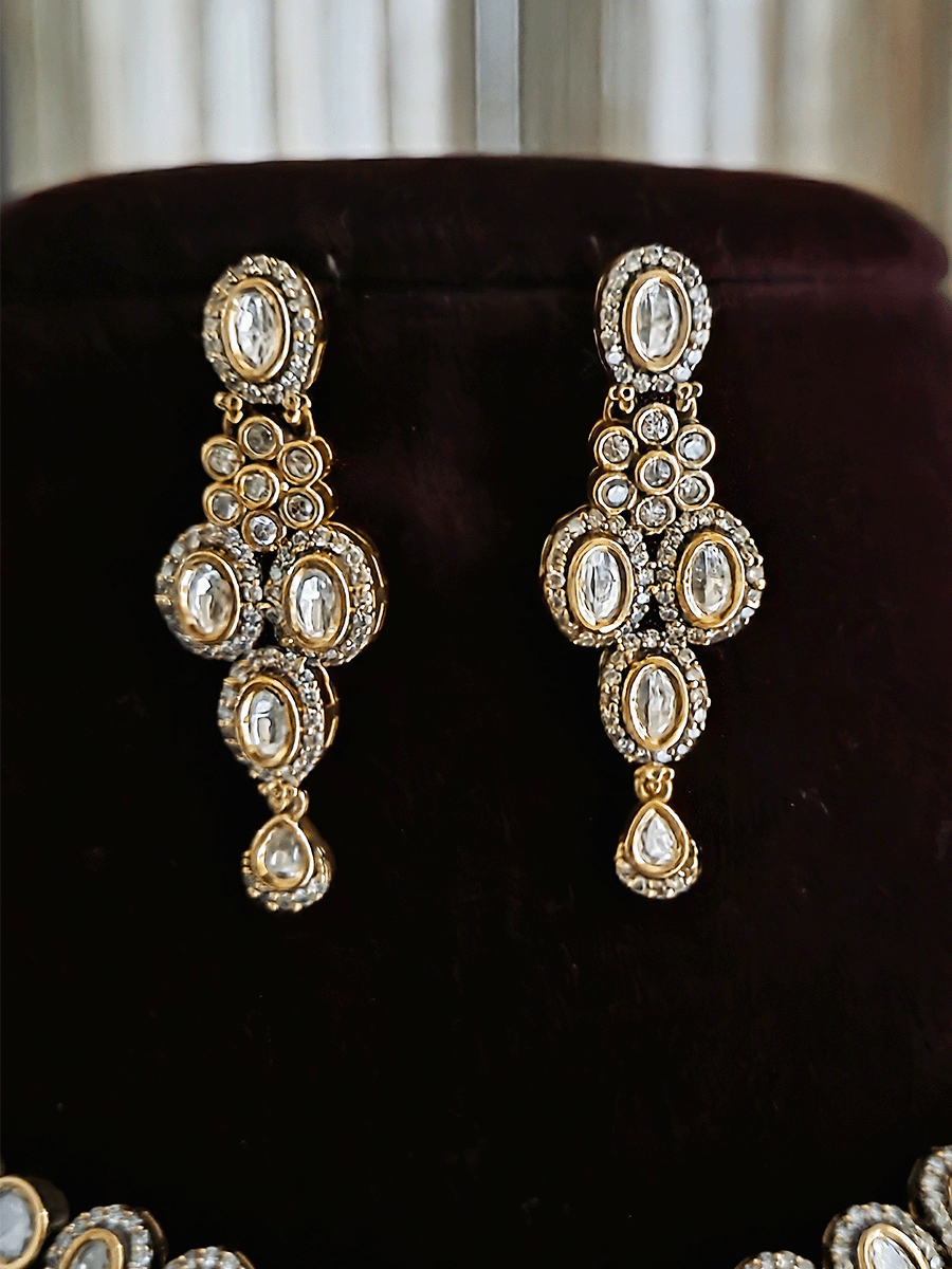 Flower in center of oval moissanite setting sleek antique gold finish set