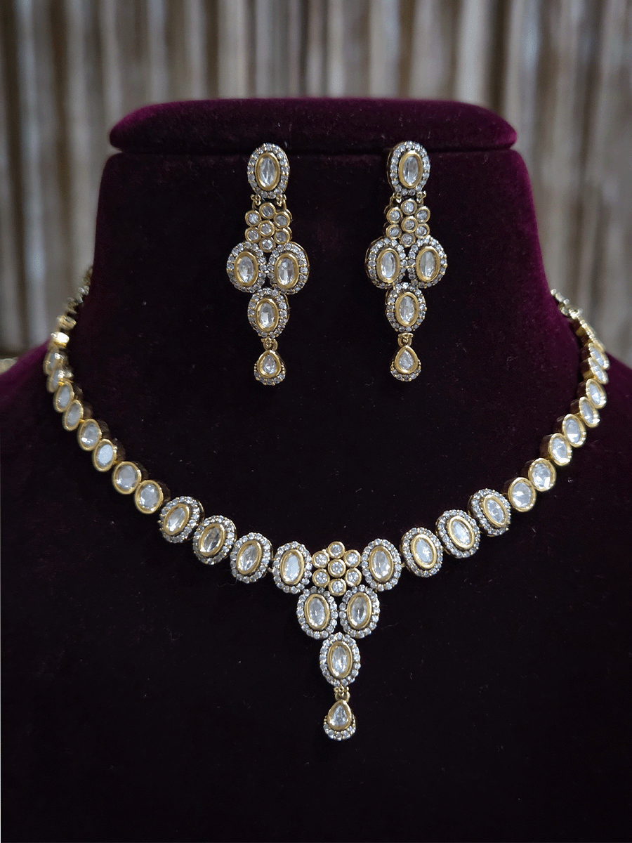 Flower in center of oval moissanite setting sleek antique gold finish set