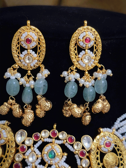 Paisley design paachi kundan center with oval side design aqua bead and ghunghru hangings set