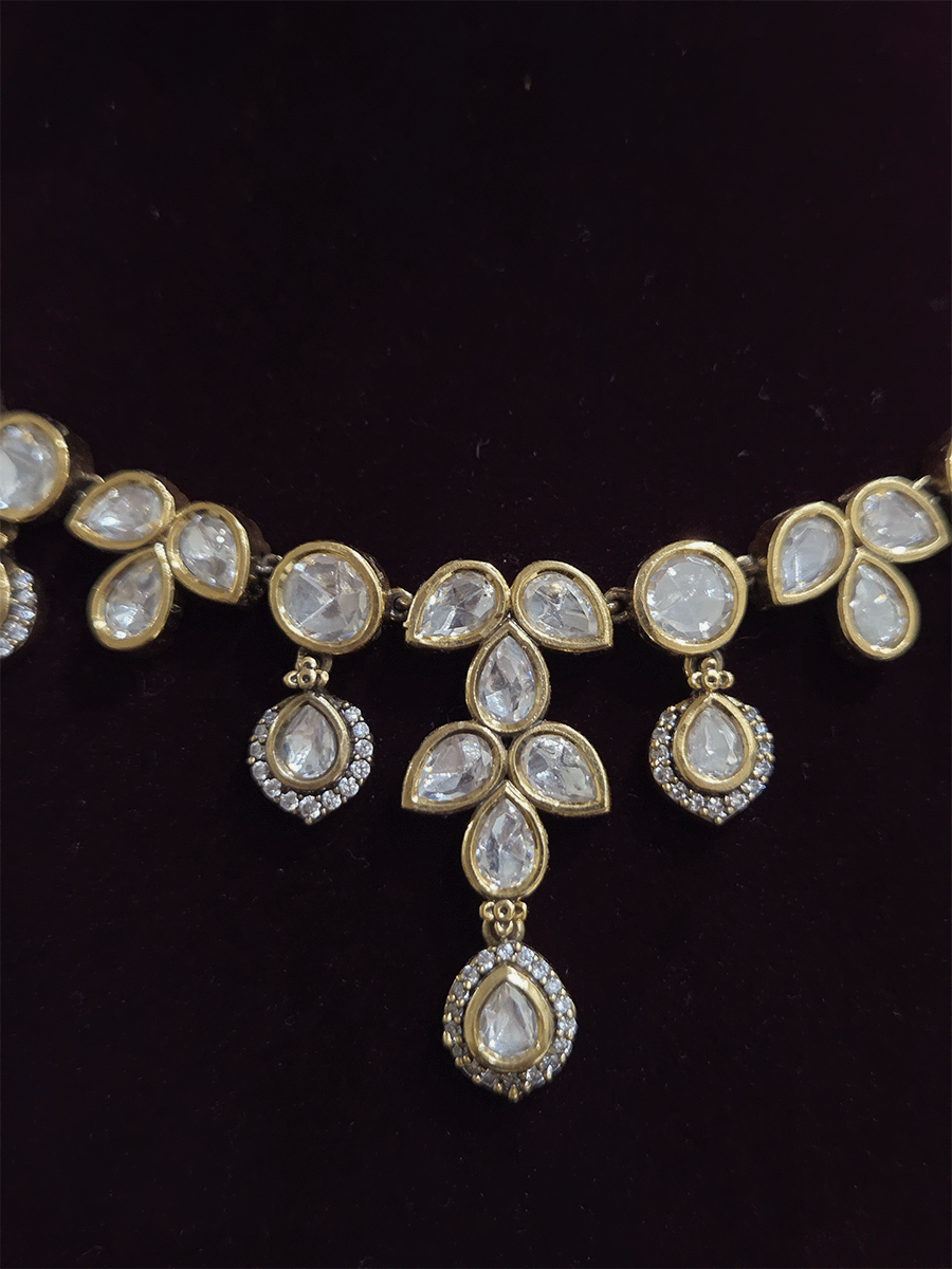 Round and tear drop shaped moissanite set with leaf shaped AD studded drops