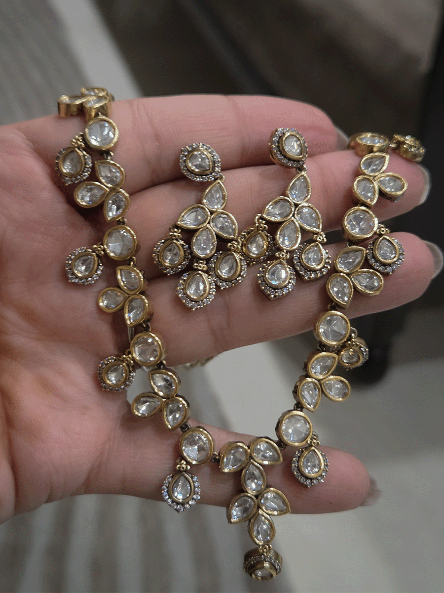 Round and tear drop shaped moissanite set with leaf shaped AD studded drops