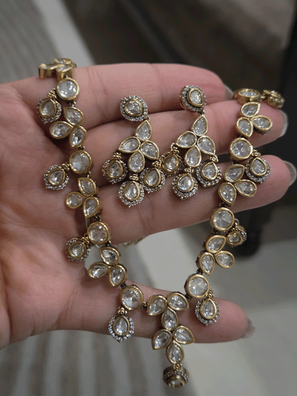 Round and tear drop shaped moissanite set with leaf shaped AD studded drops